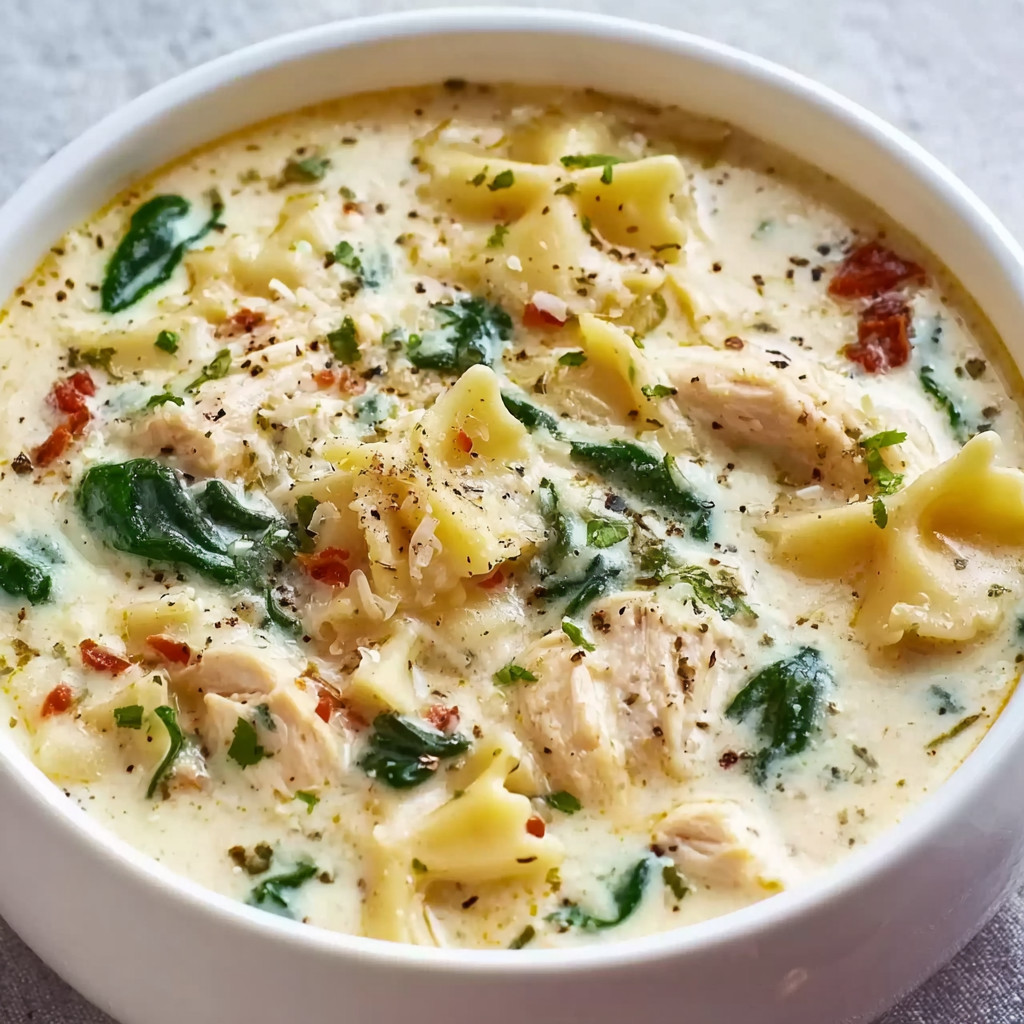 A bowl of soup with noodles and chicken.