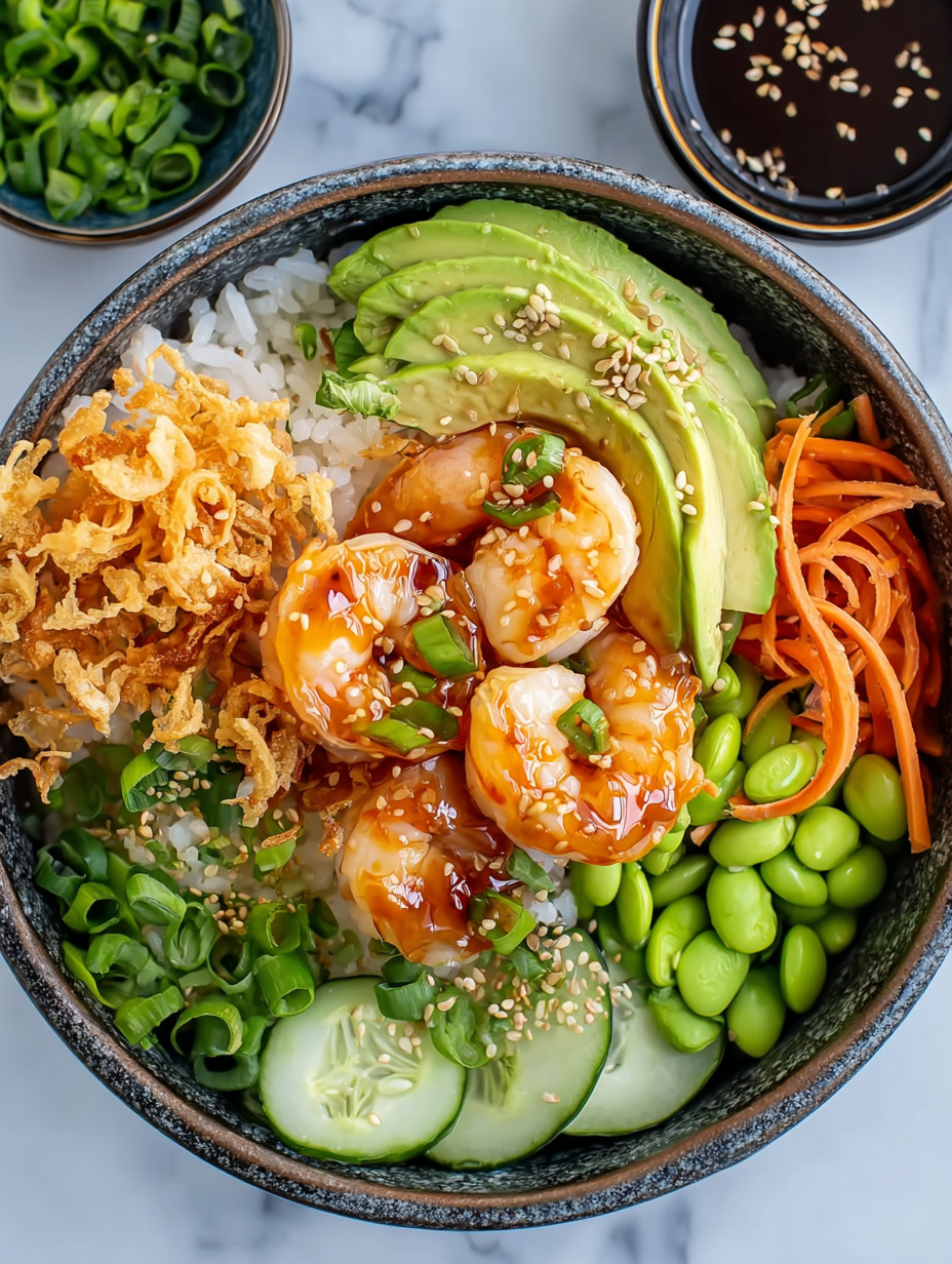A bowl of food with shrimp, avocado, and rice.