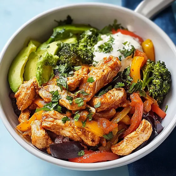 A bowl of food with chicken, broccoli, and peppers.