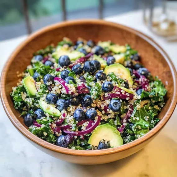A bowl of food with blueberries and other vegetables.