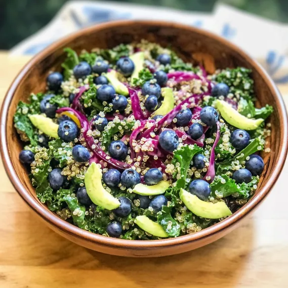 A bowl of food with blueberries and onions.