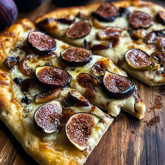 A pizza with figs on top.