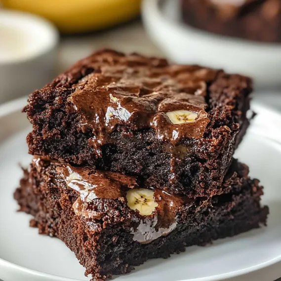 A slice of chocolate cake with bananas on top.