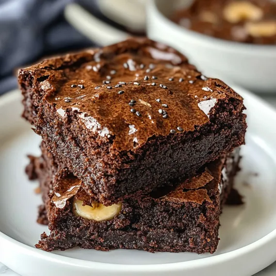 A white plate with a brownie on it.