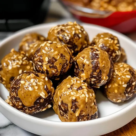 A bowl of brown balls with a spoon in it.