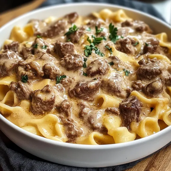 A bowl of pasta with meat and cheese.
