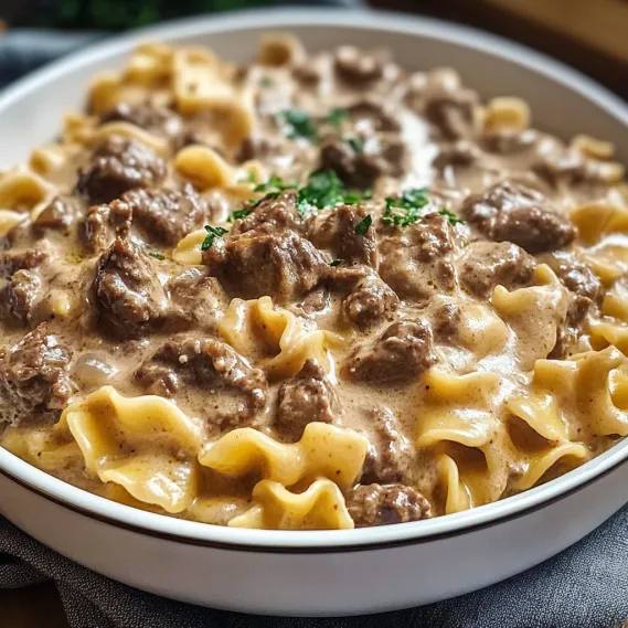 A bowl of pasta with meat sauce.