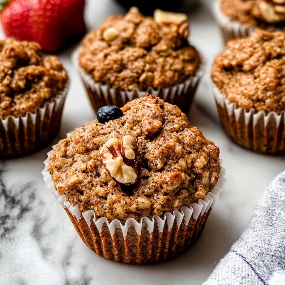 A cupcake with nuts on top.