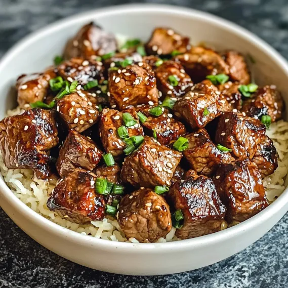 A bowl of meat with rice.