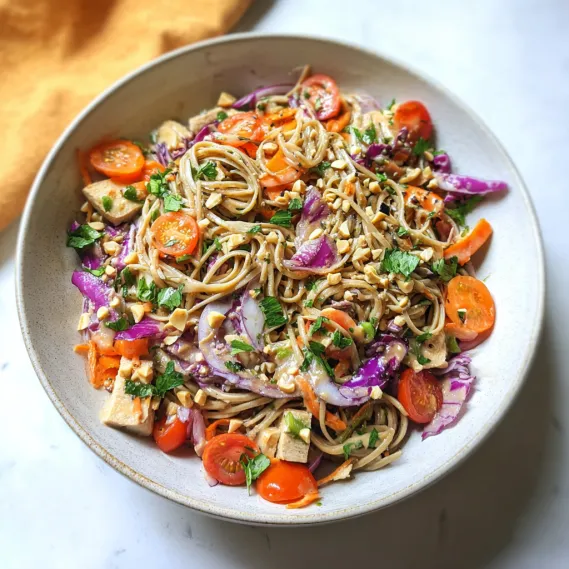 A bowl of pasta with tomatoes, onions, and carrots.