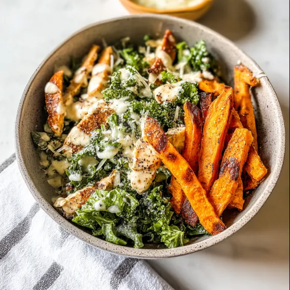 A bowl of food with chicken, broccoli and carrots.