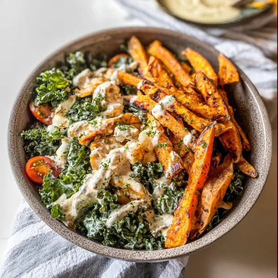 A bowl of food with a white sauce.