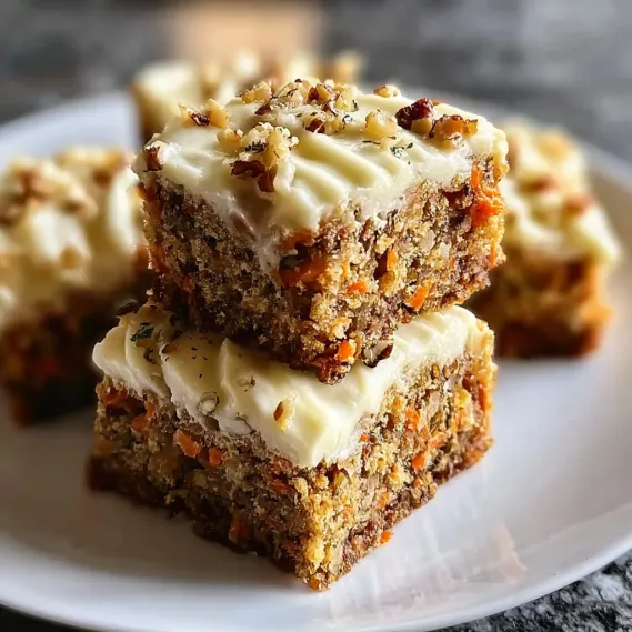 A stack of carrot cake bars on a white plate.