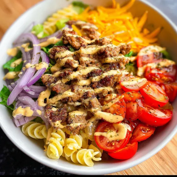 A bowl of food with tomatoes, onions, and cheese.