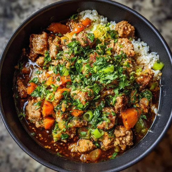 A bowl of meat and rice.