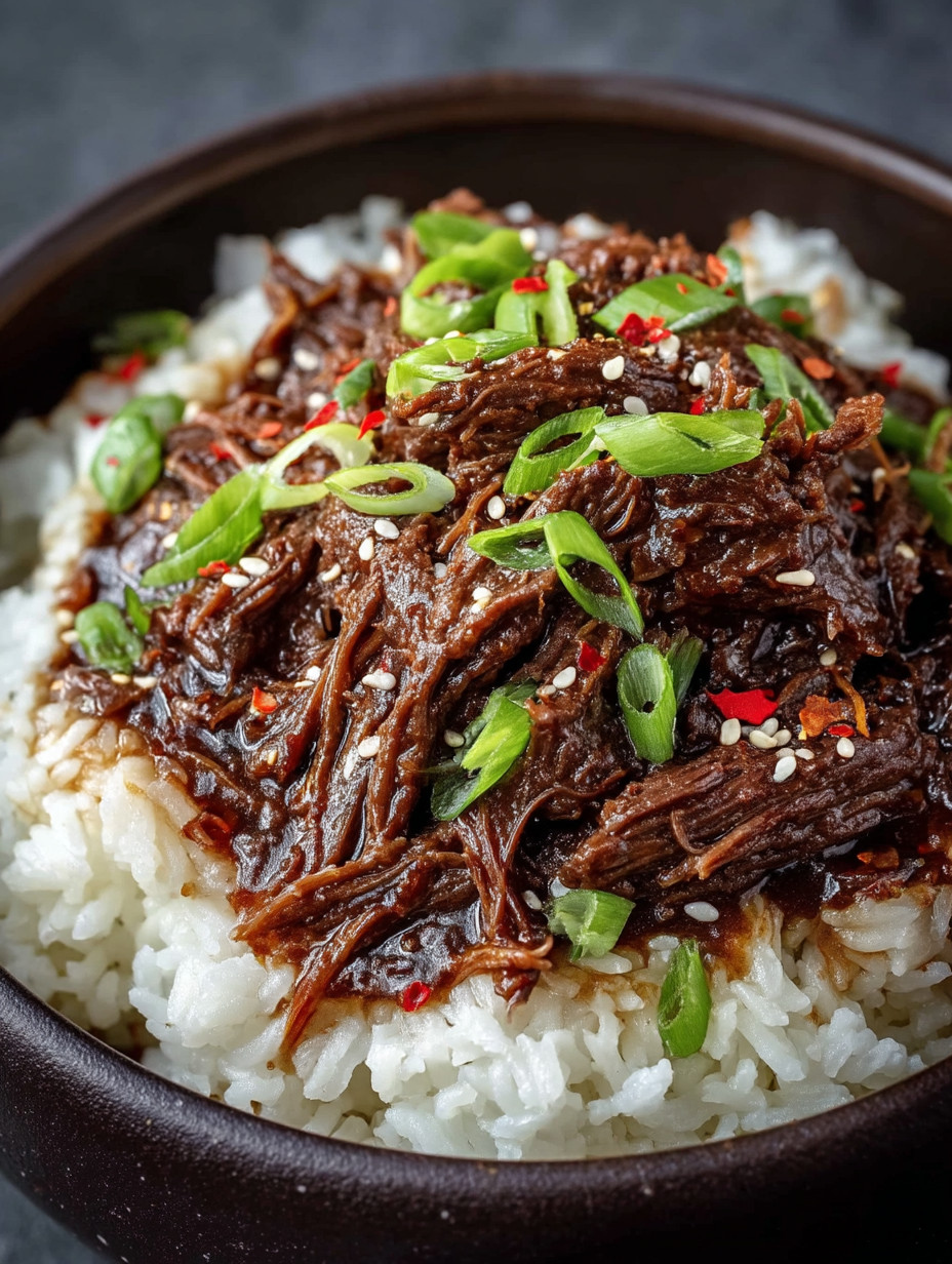 A bowl of rice with meat on top.