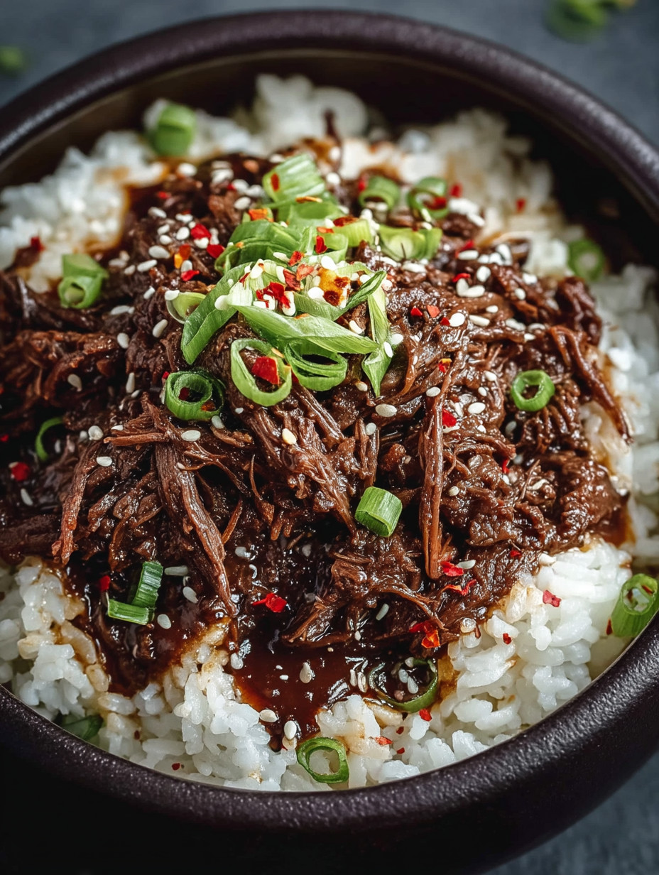 A bowl of rice with meat and vegetables.