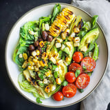 Large pieces of grilled romaine tossed with beans, corn, and slices of avocado.