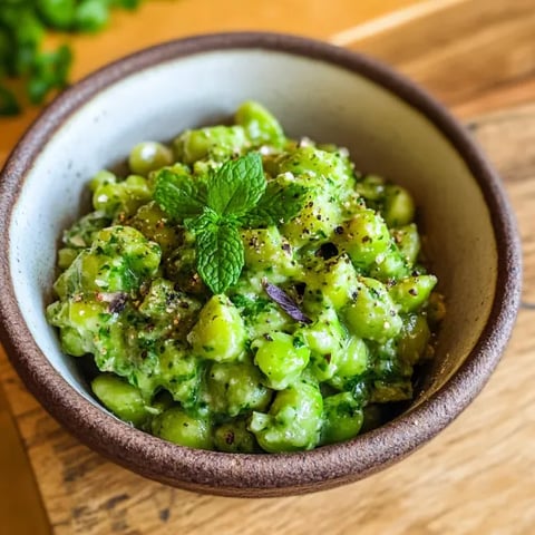 A bowl of green beans with mint.